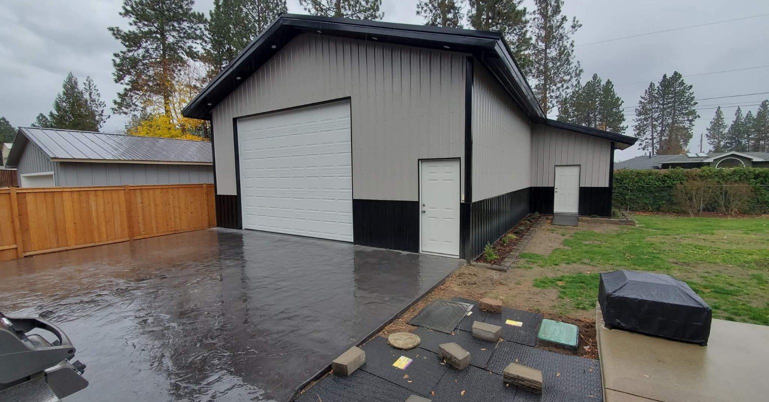 White and black pole building with concrete apron constructed by A & D Contractors LLC